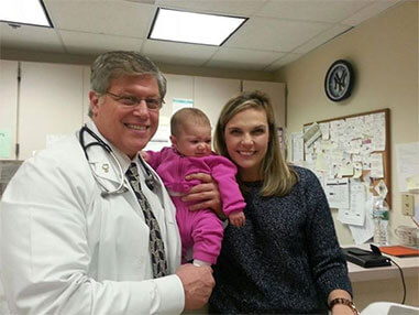 Doctor with newborn and mom
